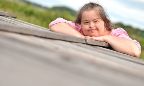 Photo of women with intellectual disability lying on the ground.