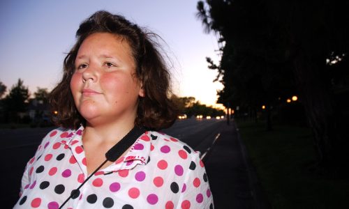 Photo of a blind woman looking into the distance at night.