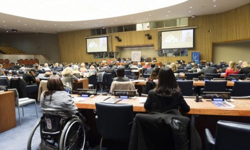 Photo of people sitting in a United Nations conference room.