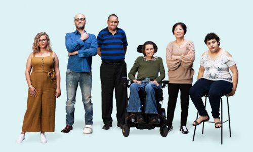 6 people with disability standing in a line against a blue background.