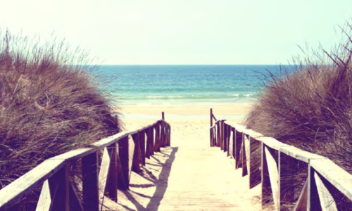 Photo of a walkway down to a beach.