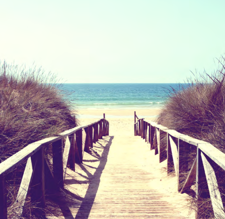 Photo of a walkway down to a beach.