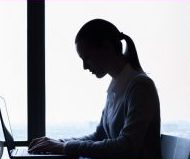 Photo of woman working on a laptop.