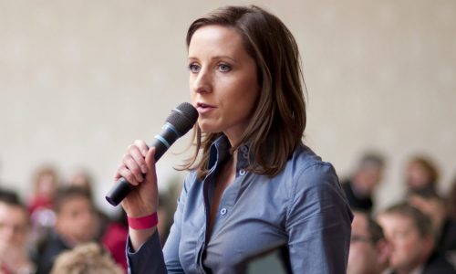 woman speaking into a microhphone.