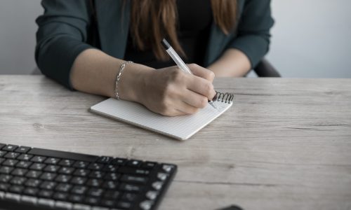 woman writing in notebook