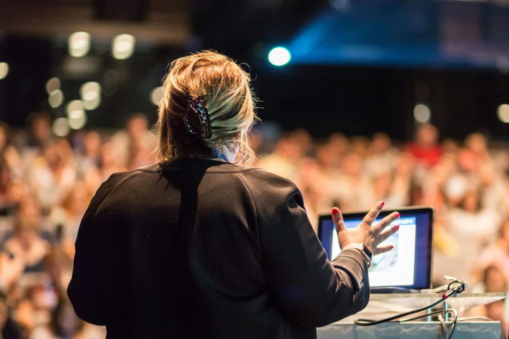 Photo of a woman speaking to a crowd.