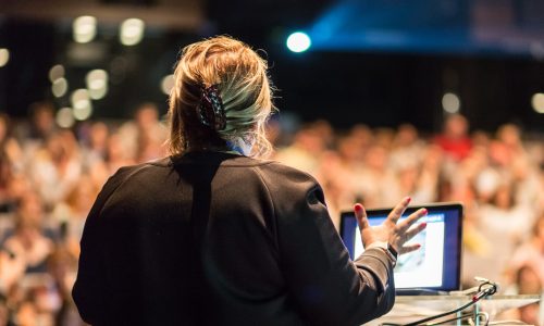 Photo of a woman speaking to a crowd.