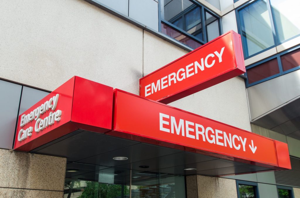 Photo of a red emergency sign on the side of a building.