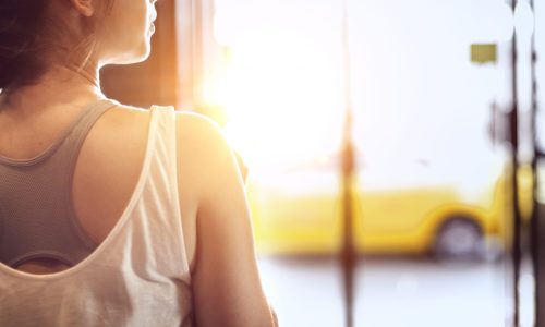 Photo of a woman looking out a window.