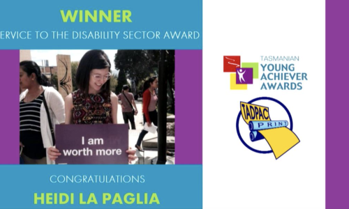 Photo of Heidi La Paglia holding a sign that says I am worth more, Heading reads winner, TADPAC Disability Sector Award.