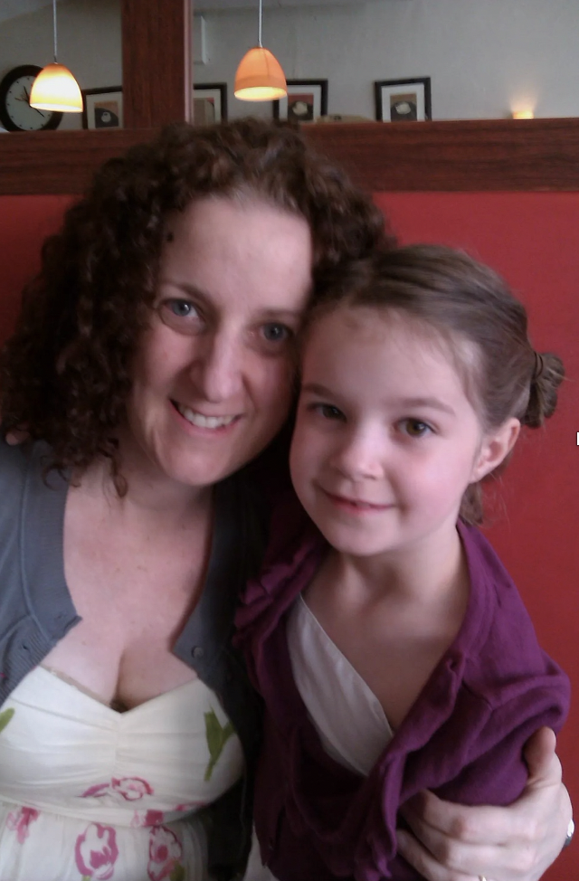 Photo of young Issy (right) with their mum (left).