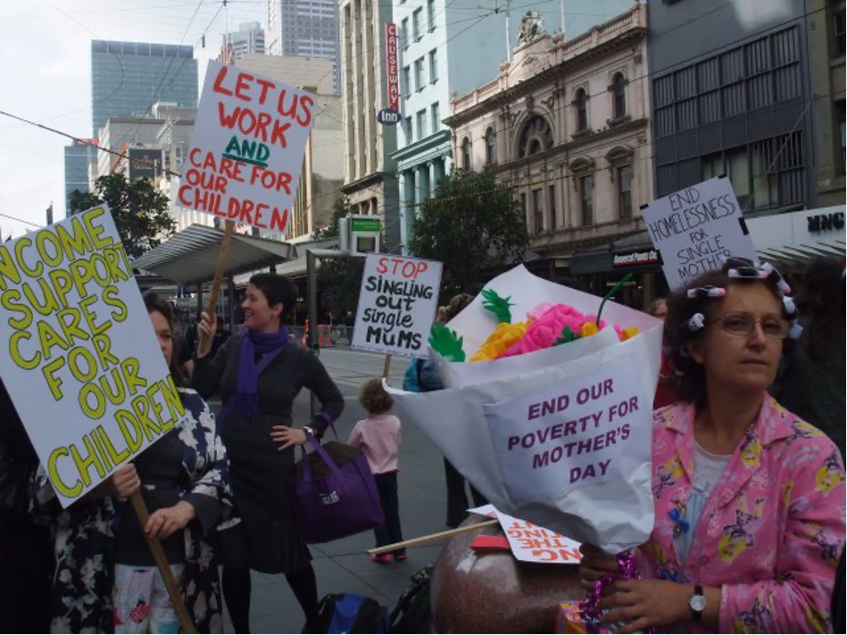 A photo of Helen (right) in 2010, protesting in a crowd with the Council of Single Mothers.