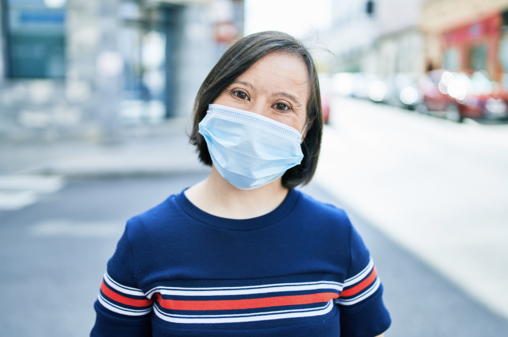 A woman with disability wearing a mask.