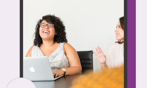 [Image: Light purple background with a dark purple shadow, the photo in the centre is surrounded by a black border, the LEAD logo is in the bottom left corner and text reads ‘LEAD Women With Disabilities Australia (WWDA)’, the photo is of two women talking to each other, one of the women is behind her laptop and she has dark curly hair and is laughing, the woman to her right has dark brown hair and has her hand up.]